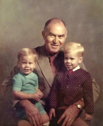 Grandfather Buel Smith with two young grandsons on his lap.