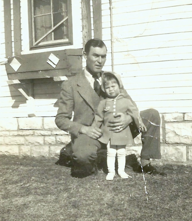 Young father Buel M. Smith holding his toddler daughter, Phyllis Ann Smith.