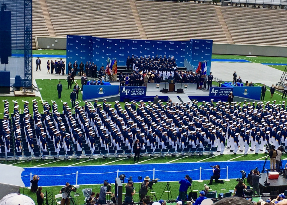 View of stage and graduates at 2019 Air Force Acedemy Graduation with President Trump on stage.