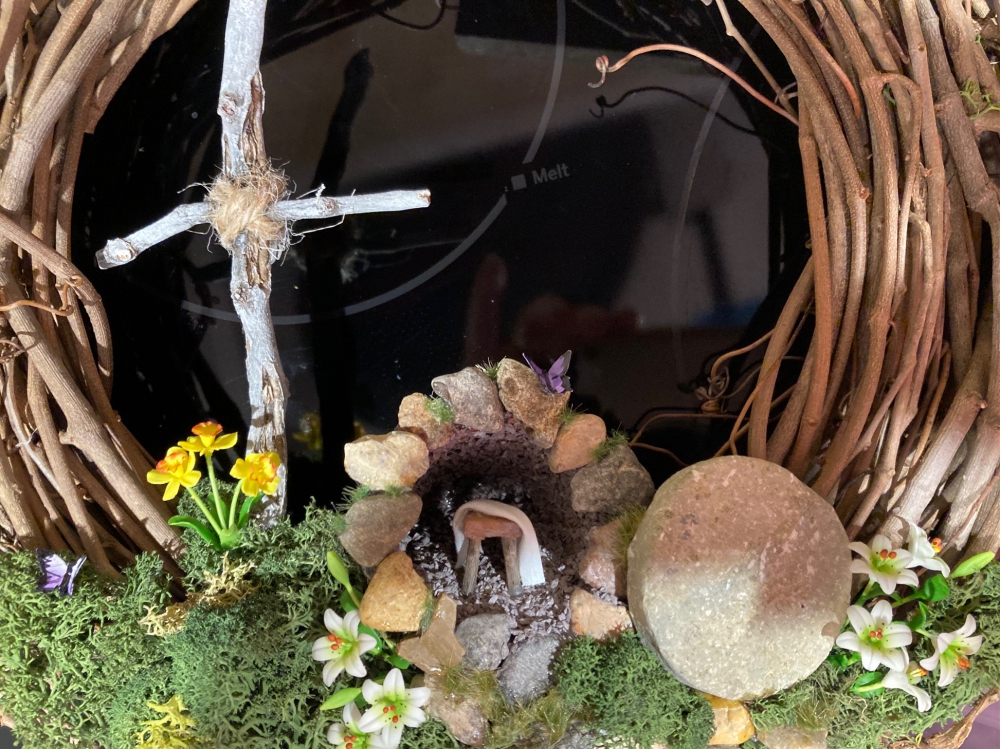 Close up of the cross and tomb area of the Easter Wreath showing the grave cloth draped.