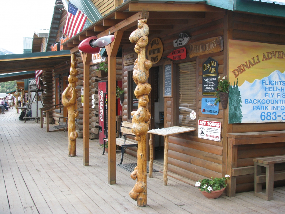 An Alaskan outdoor mall with posts showing lots of knots and deformities.