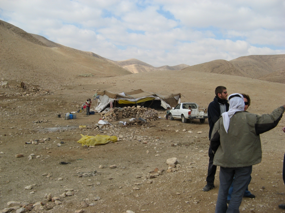 Tent home of Bedoine couple with three small children in middle of Judean Desert showing their tent and small pickup truck.