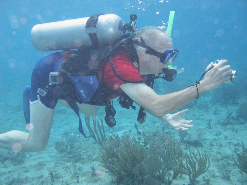 Monty Kester in scuba gear taking underwater pictures