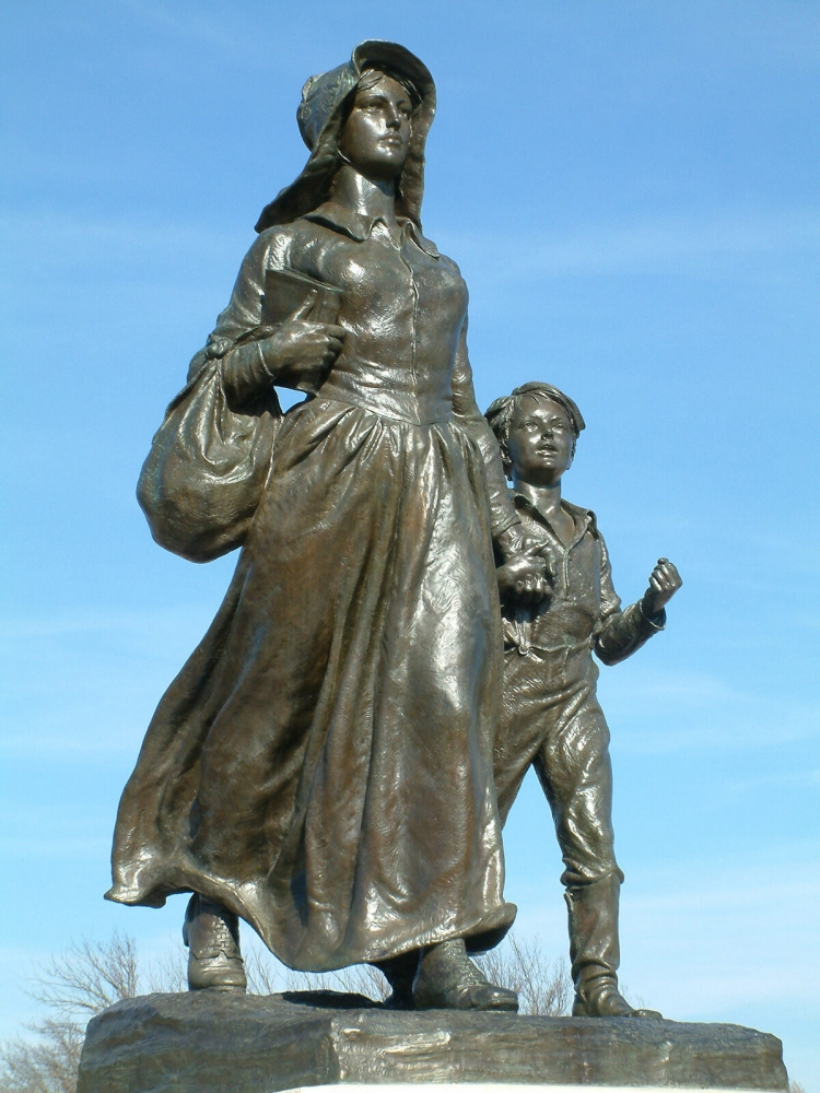 An up close view of the bronze Pioneer Woman and son statue in Ponca City, Oklahoma, that shows the facial expressions of mother and son.